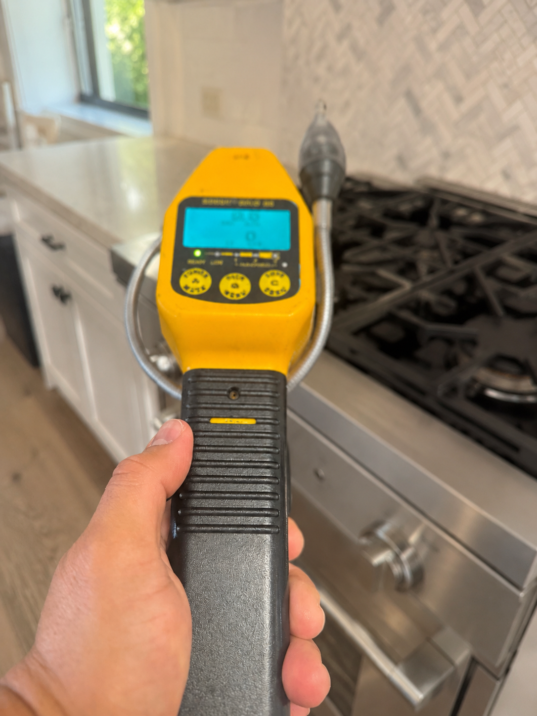Gas detection meter being used near a residential gas range